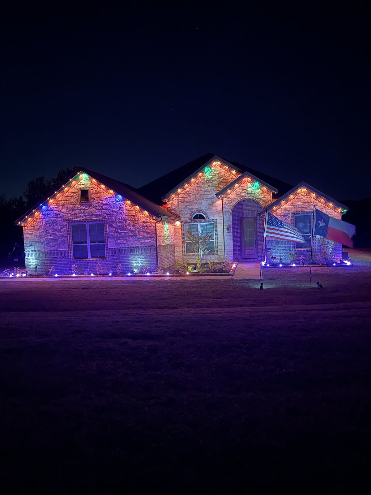 Crisp white permanent LED roofline lighting on a two-story home